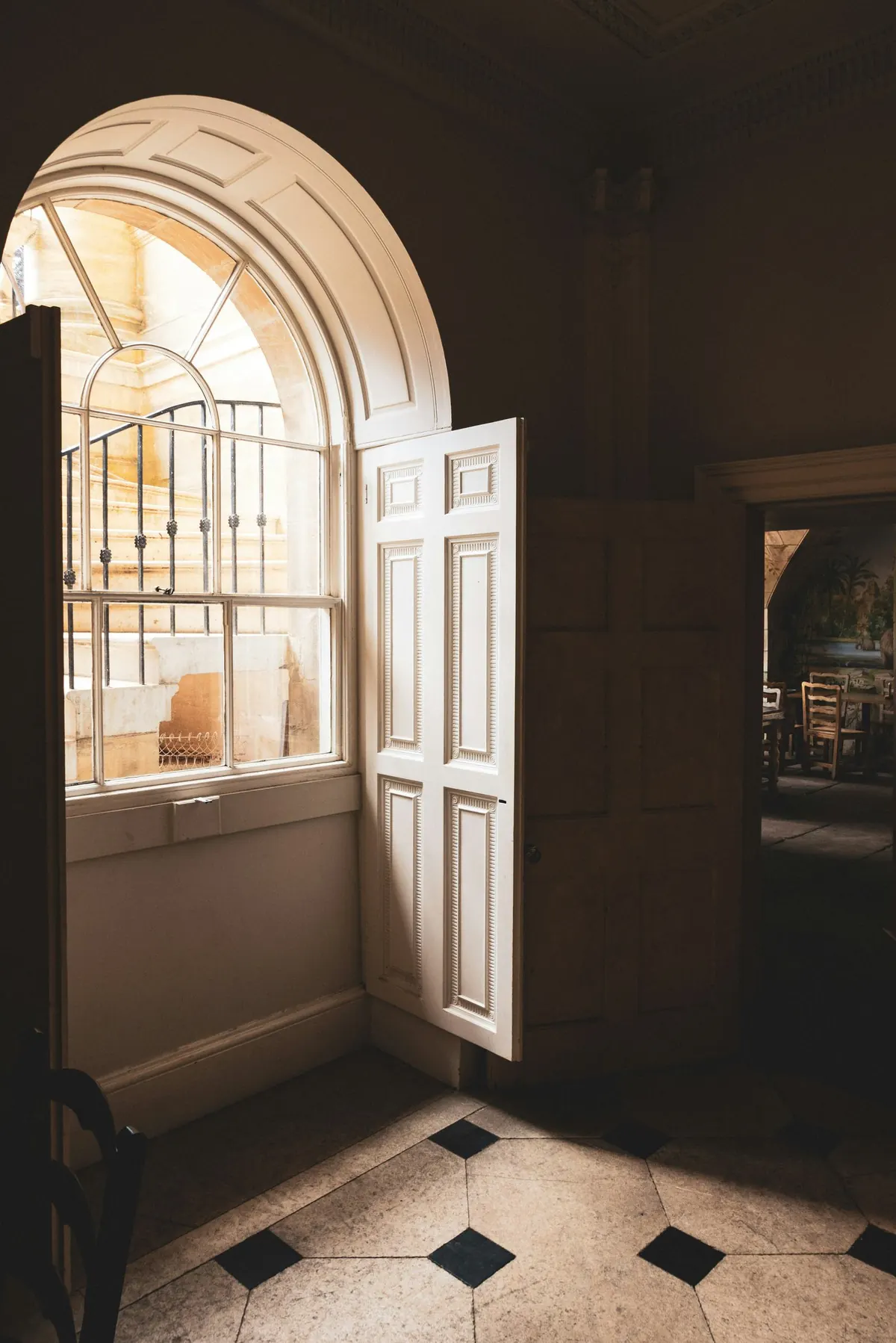 An arched window in a panelled interior