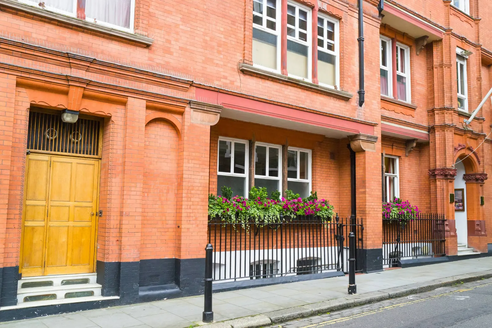A brick terrace with sash windows and window boxes