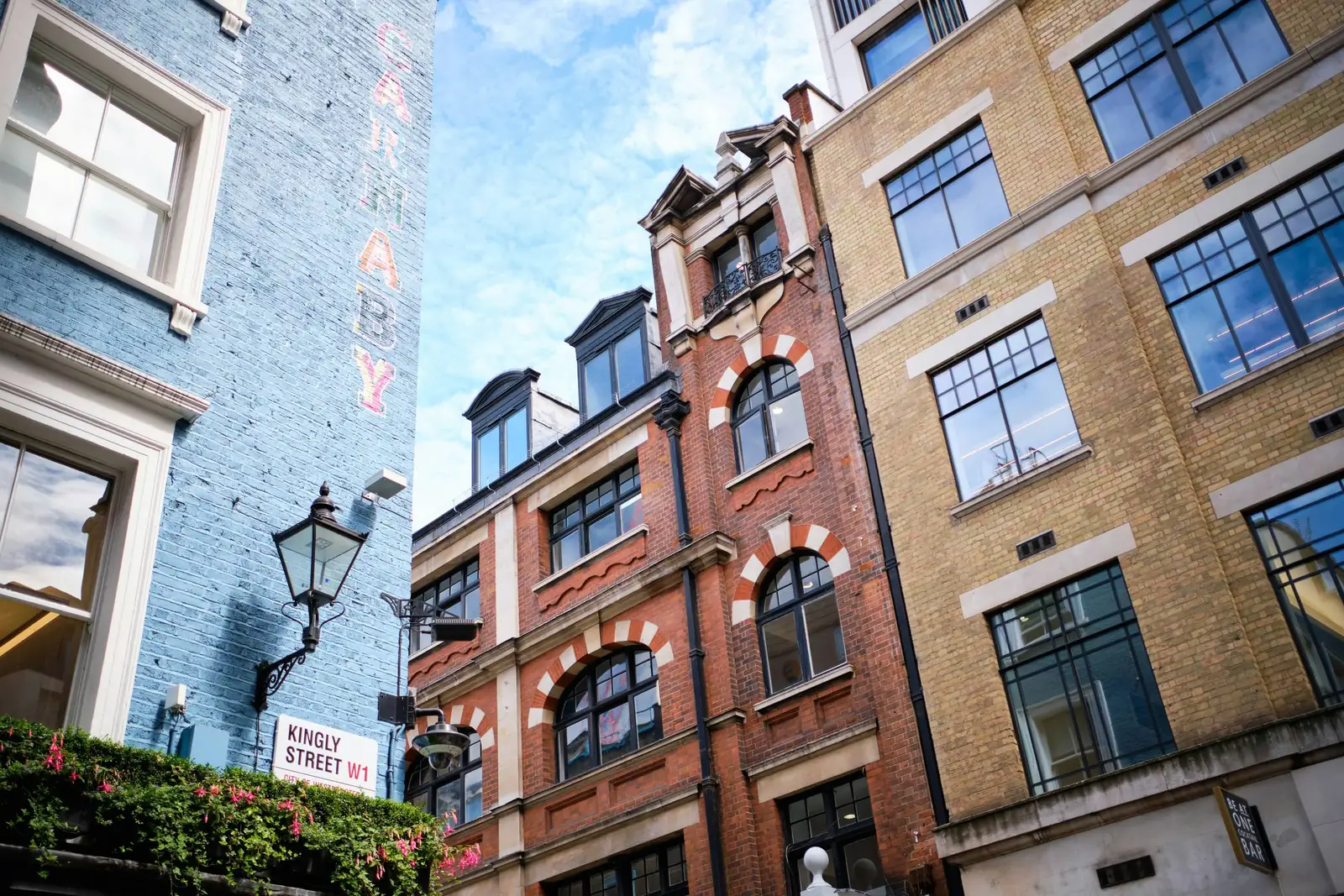 A brick frontage with sash windows beside a street lamp