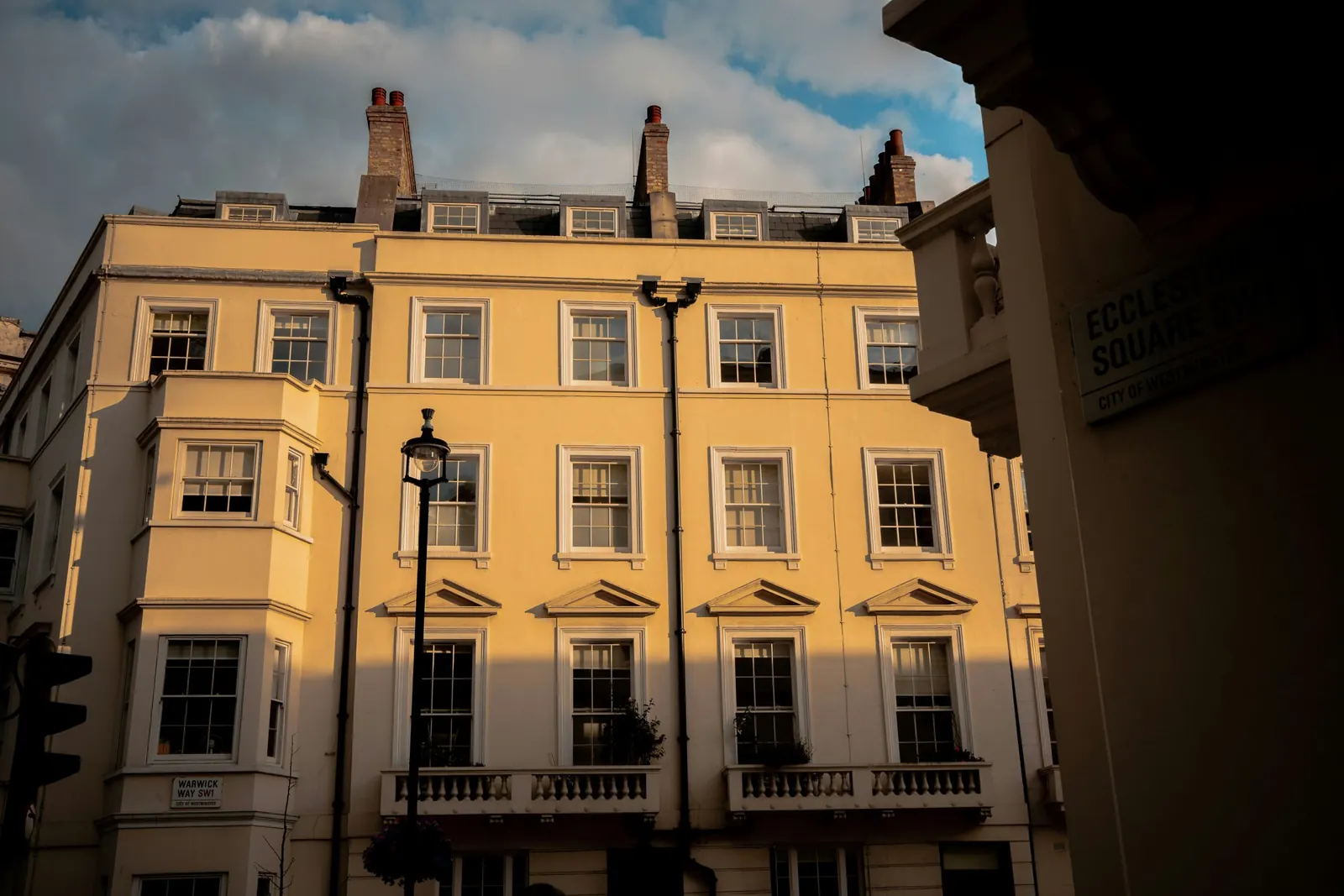 A stucco terrace with tall sash windows to every floor