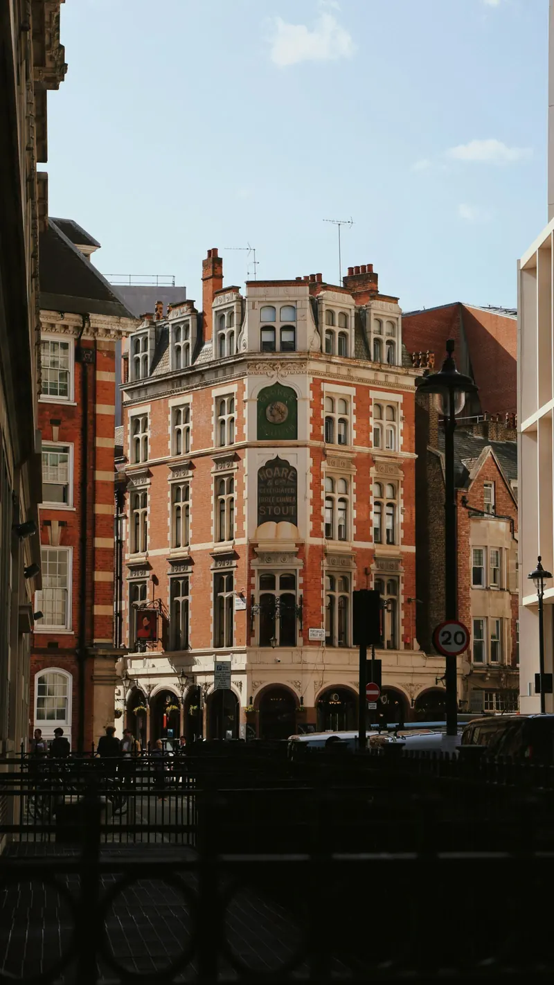 A red brick mansion block with bay sash windows to every floor